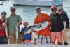 Walter Moulaison and his son, Jacob, center, caught a 47-inch striper aboard the Redhook on August 19. Courtesy of Mark Stover