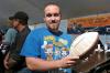 Dylan Geyer of Boothbay Harbor shows the crowd a football signed by the players of the 1972 Miami Dolphins. The Dolphins went undefeated in 1972, going 17-0 and winning the Super Bowl against the Washington Redskins. The football went for $120. KATRINA CLARK/Boothbay Register 